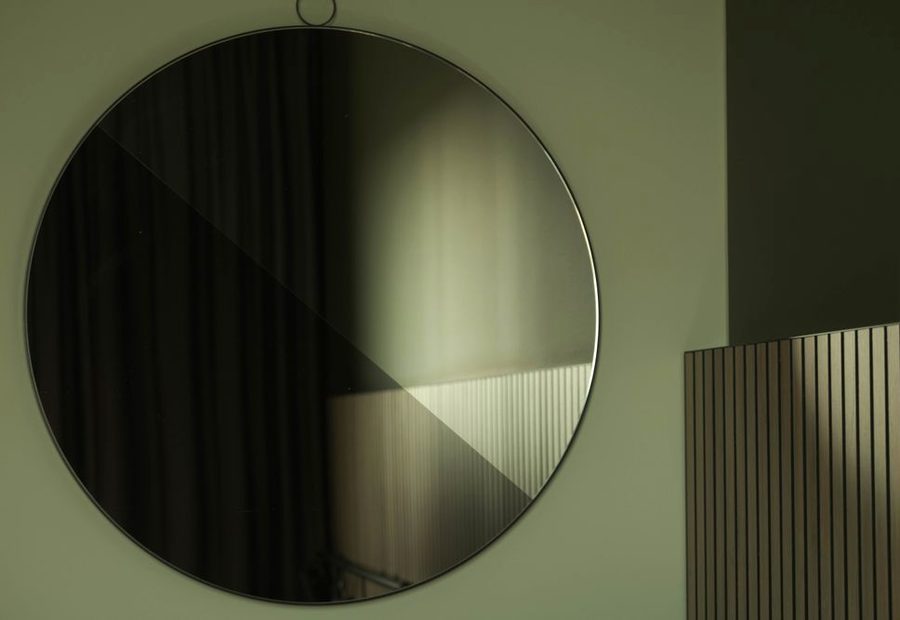Round black-framed wall mirror